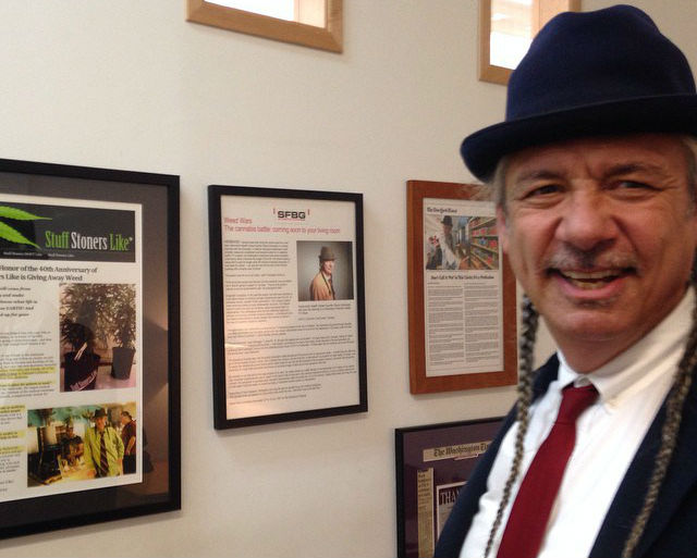 Steve Deangelo founder of Oakland's Harborside Health Center poses near a framed Stuff Stoners Like post in his office